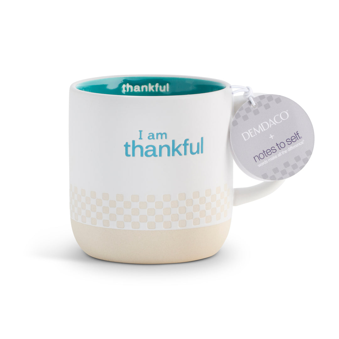 Mug with 'I am thankful' text and Demdaco tag on a white background