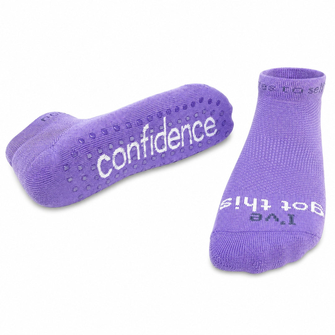 A pair of purple ankle socks on a white background, one showing the non-slip grip sole with the word 'confidence' in white, and the other showing the top with the text 'I've got this' in white.