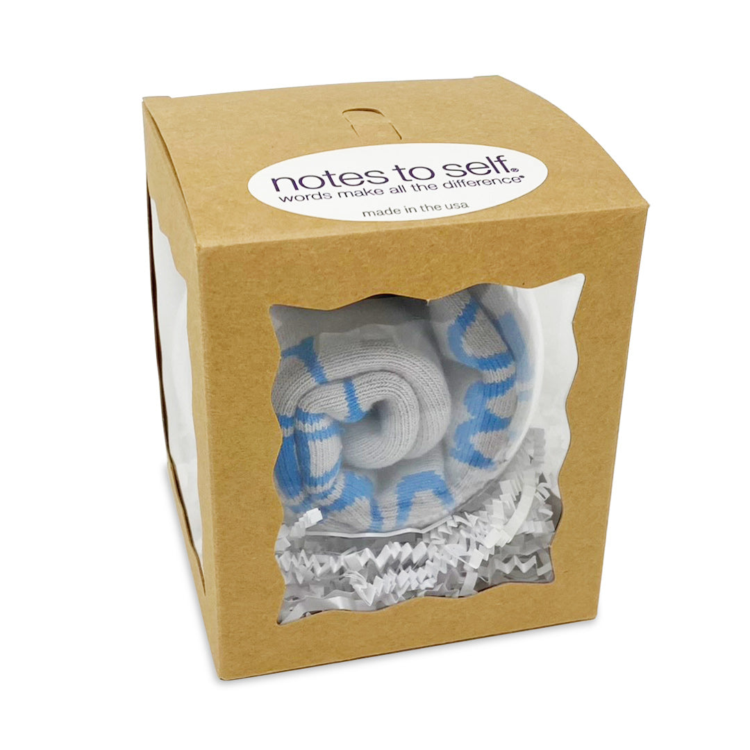 the world needs me sock ornament in box